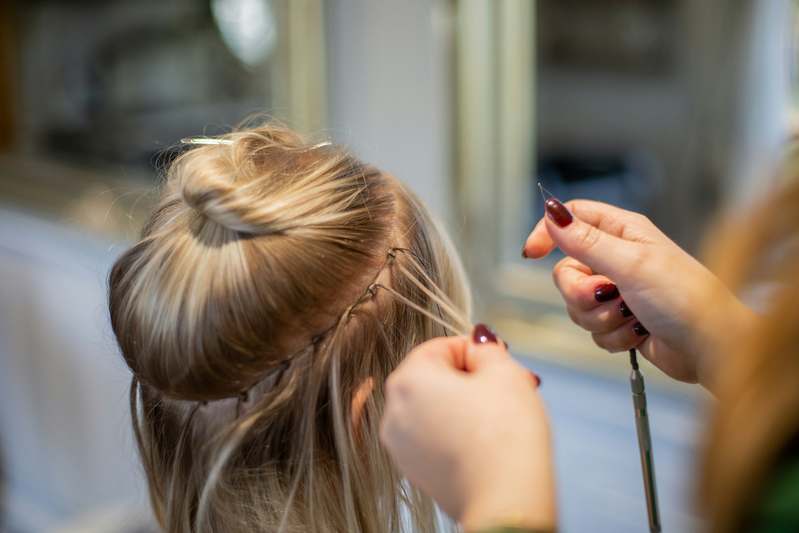 Close-up of high-quality hair topper laid on velvet fabric with natural lighting